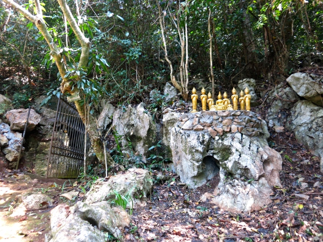 Entrance to the cave with little Buddha figures nearby