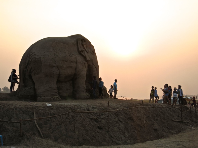 Elephant sand sculpture at sunset