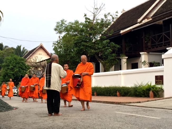 Tak Bat, the alms-giving ceremony. The oldest monks lead the procession.