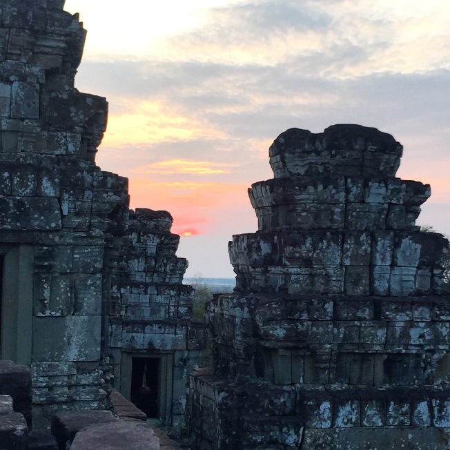 Sunset through the towers of Phnom Bakheng