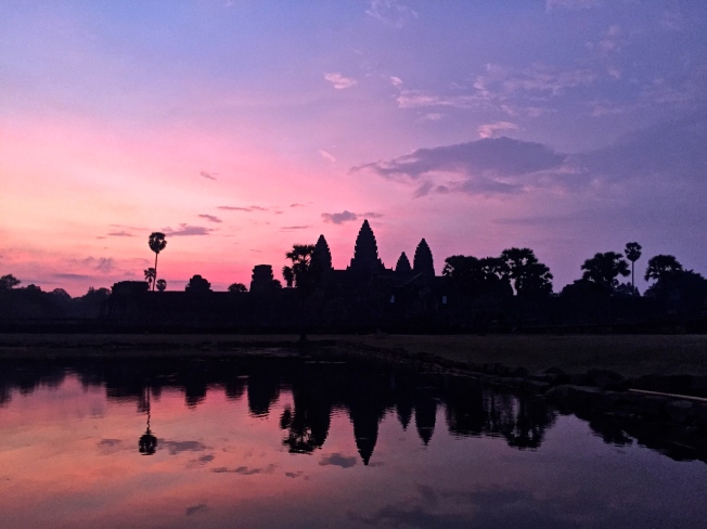 First rays of morning behind Angkor Wat